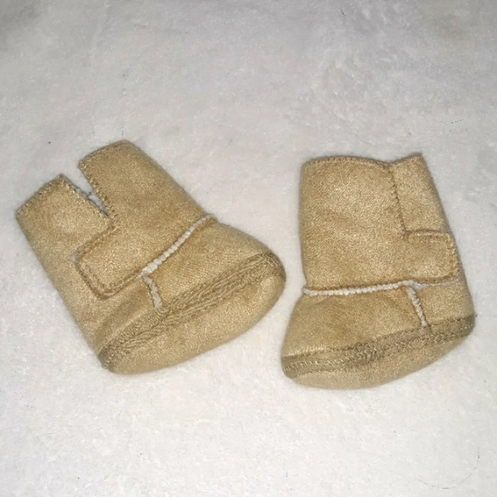 Newborn Tan soft baby boots with warm inner layer.